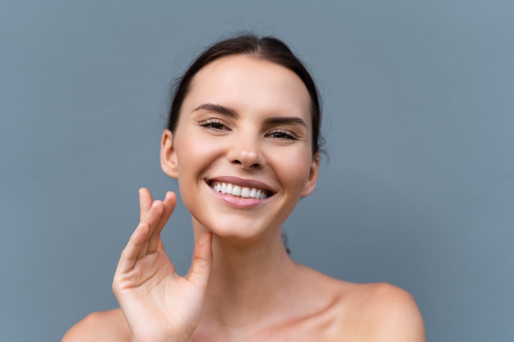 Beauty portrait of woman with perfect skin and natural makeup, full nude lips
