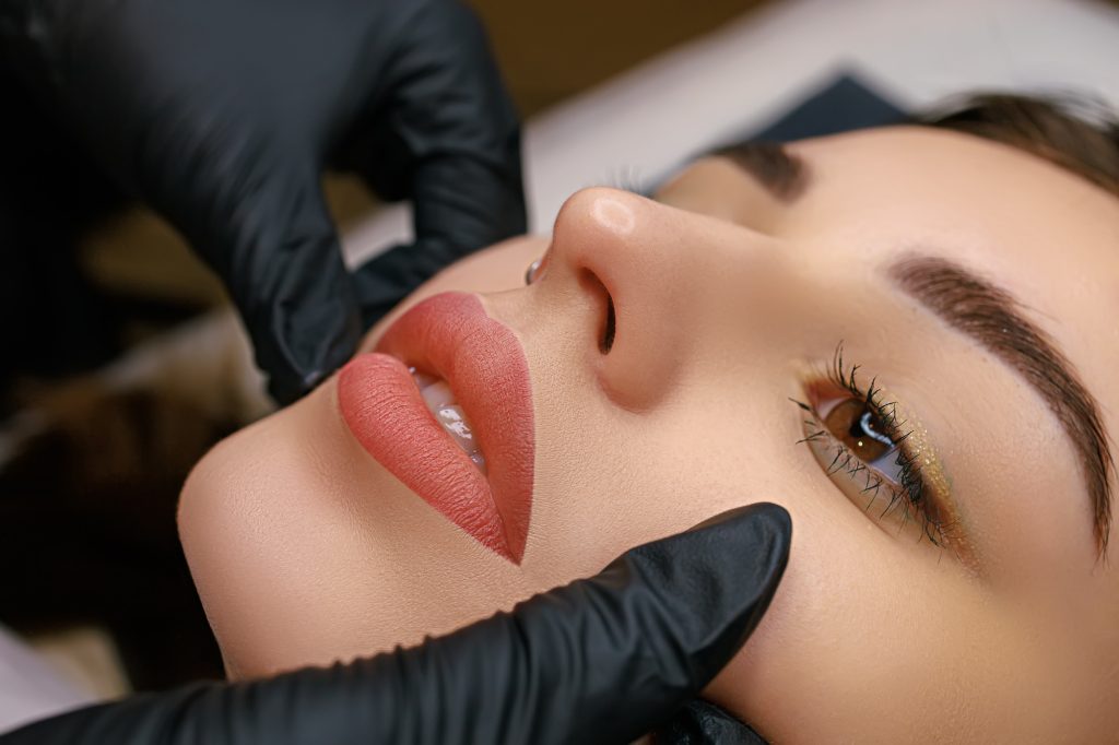Finished work on permanent lip makeup for a model, lips close-up